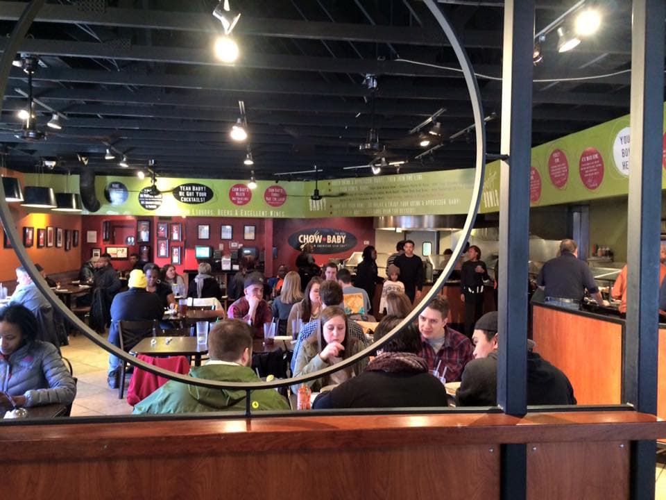A bustling restaurant interior with patrons dining.
